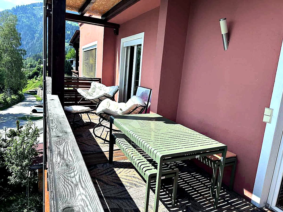 Terrace with outdoor dining area and view of the Drau valley