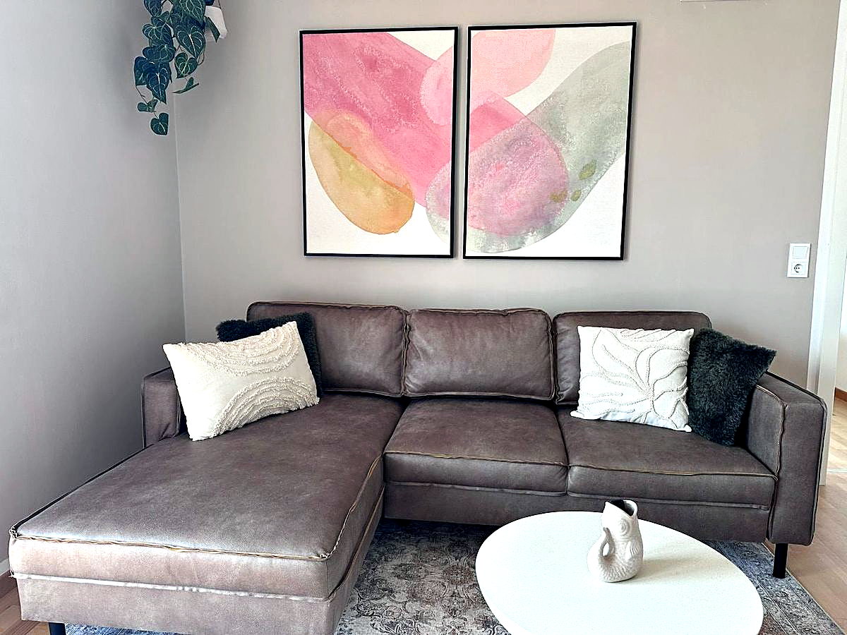 Woonkamer van vakantieappartement Sonnweit met leren bank en deur naar het terras